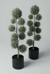 Studio · Three-quarter studio view of the olive pair, pom-pom pads staggered around each pale trunk.