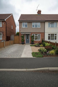 Showcase · Street view of the semi-detached house with the clipped privet pair framing the front door