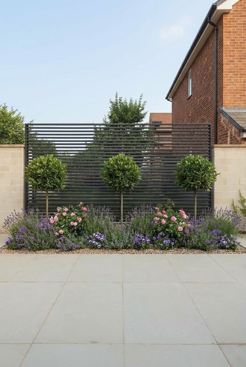 Showcase · Three bay lollipops behind pink roses, lavender and violas on a gravelled bed