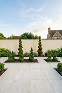 Showcase · Symmetrical terrace view with spirals at three heights framing a rendered garden wall